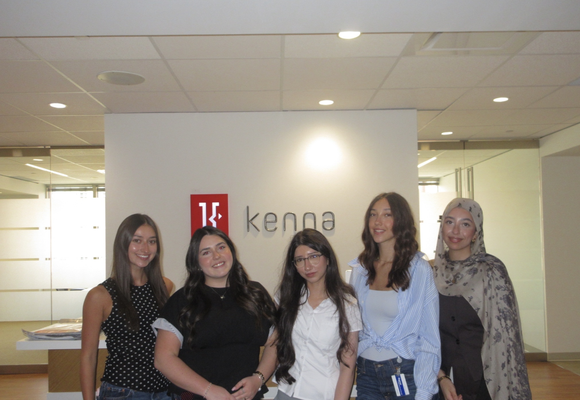 Co-op students posing together in front of the Kenna office sign